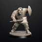Gray warrior figurine with axe and shield on a black background